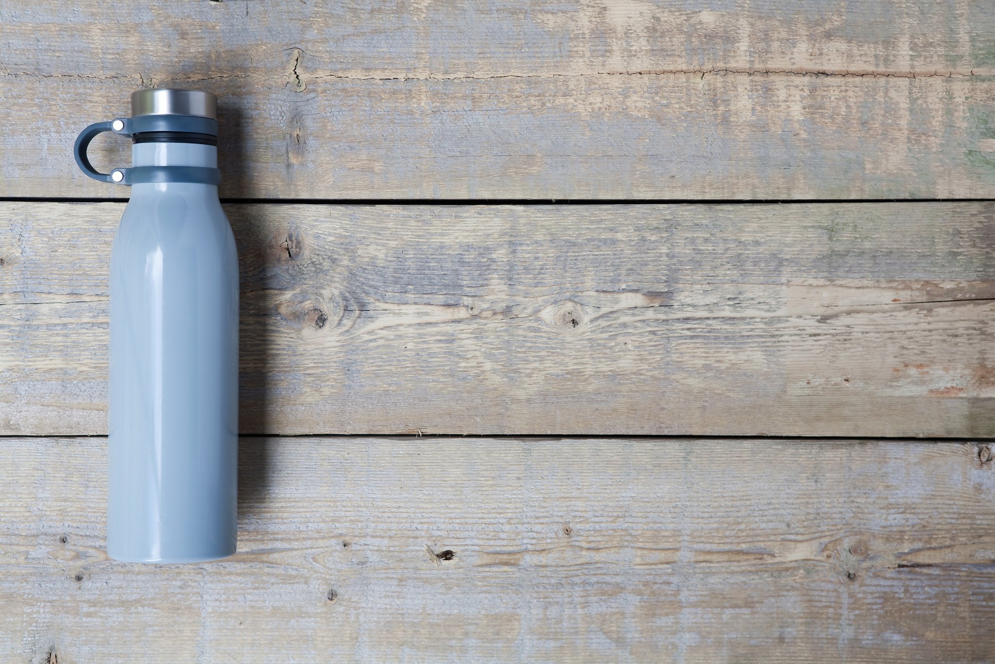 Stainless steel water bottle on wooden table