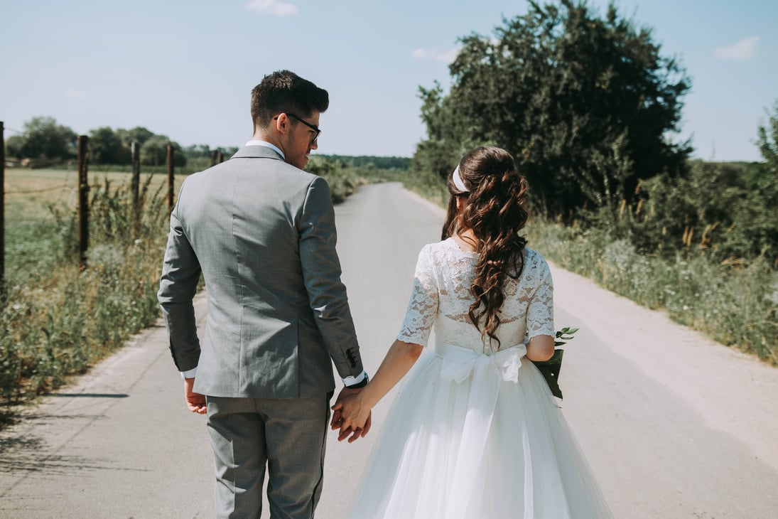 Newly Wed Couple Walking Down the Road 