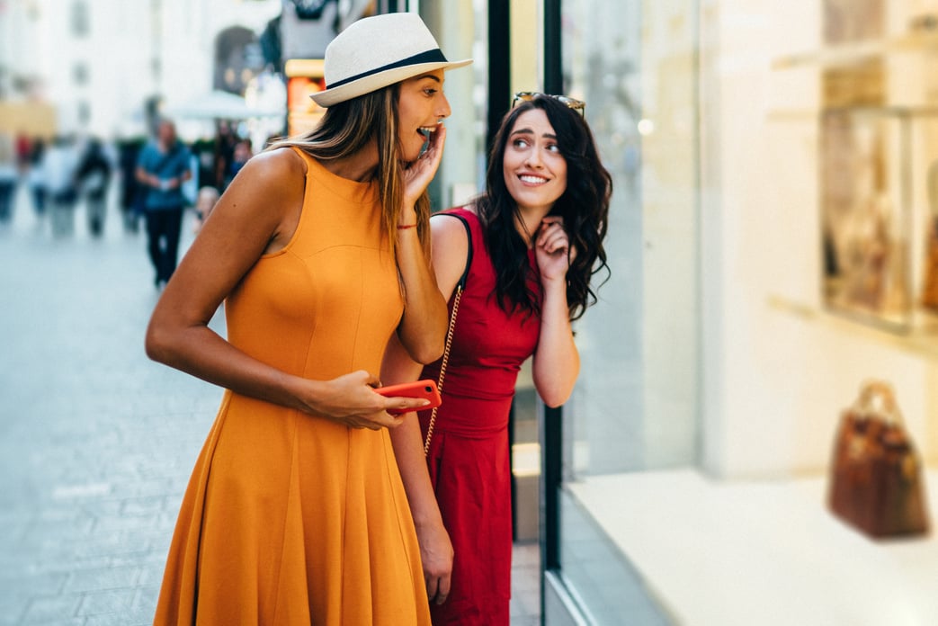 Friends on shopping choosing luxury handbags